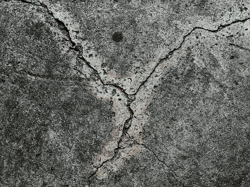 Cracks running across a grey concrete slab