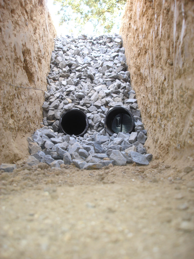 Perforated drain pipes laid in a gravel-filled trench