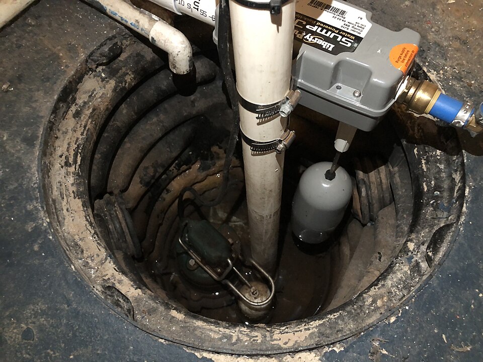 A sump pump with a float switch in a basement sump pit